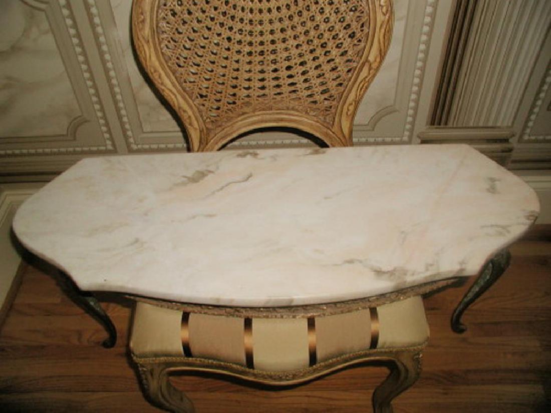 Italian Console Table Marble Top Gilt Early 1900's: Early 1900's Italian console table with attached marble top in antique cream background and camel and light brown veining with a hint of pink in some veins. Ornate gilt wood apron depicts acanthus lea