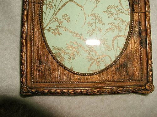 Gilt Wooden Frame With Glass 19th C France Carved: Beautiful 19th century wood antique gilt frame with glass and raised carved floral swag above the oval opening with tiny bead trim. Additional ornate raised floral surrounds the outside of the frame a