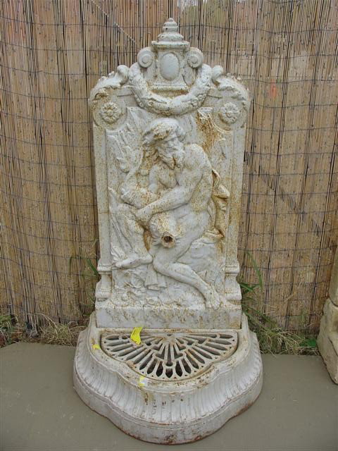 French Cast Iron Wall Fountain: This is a painted wall fountain made of cast iron. It is still in good condition, besides some rusting, and a hairline crack that does not affect structural strength.