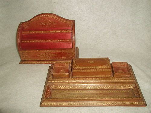 Leather Desk Set Gold Tooled Italy 19th Century: Handsome camel leather desk set with gold tooling from Italy 19th century. Built in pen tray has glass over the leather for protection. The larger tray has attached open leather boxes either side with