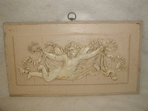 French Cherub Plaque 19th Century Hand Carved: Rectangular 19th century wooden French cherub plaque was hand carved and shown in original light tan background with antique white cherub and swag paint. The adorable curly headed cherub holding the m