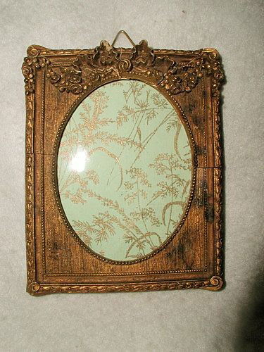Gilt Wooden Frame With Glass 19th C France Carved Heade: About the Item: Beautiful 19th century wood antique gilt frame with glass and raised carved floral swag above the oval opening with tiny bead trim. Additional ornate raised floral surrounds the outsi