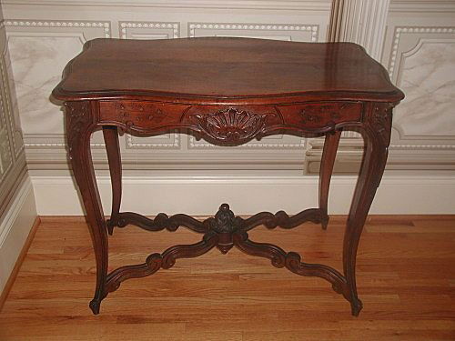French center table walnut hand carved 19th century han: About the Item: Very handsome hand carved French mid 19th century center table of walnut. Designed with one drawer at the more narrow end so that can be used between two chairs or long ways along a w