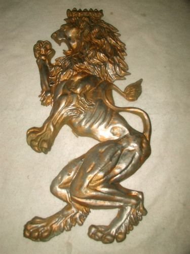 French Metal Lion Wall Hanging Early 1900's: Pewter colored French metal upright lion wall hanging from the 1920's. Dark gold accents highlight his mane and muscular body. Crown atop the head. Two protrusions made into the back allow for a wire 