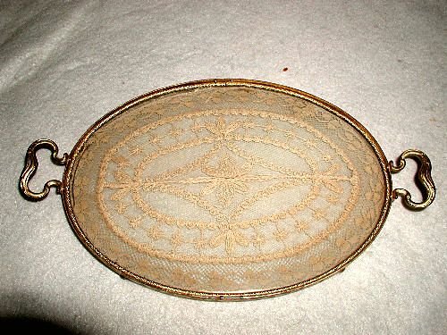 Vanity Dresser Tray France 19th C Hand Made Lace Insert: About the Item: Dainty oval brass dresser or vanity tray from France 19th century has a floral design of hand made lace well protected between two pieces of glass. Two brass handles,tiny ball feet and