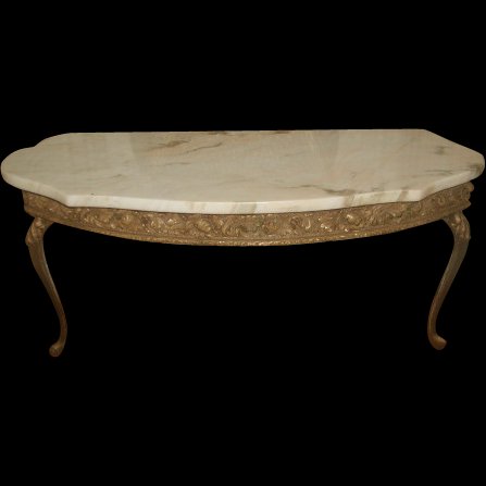 Italian Console Table Marble Top Gilt Metal: Early 1900's Italian console table with attached marble top in antique cream background and camel and light brown veining with a hint of pink in some veins. Ornate gilt wood apron depicts acanthus lea