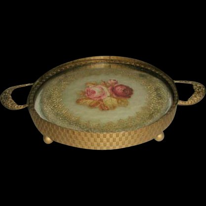 French Vanity Tray 19th Century Petti-Point Brass: C.1850-65 petite vanity or dresser tray with ornate brass floral handles either side,decorative banding on side and brass ring top and bottom of the 2 pieces of glass. Stands on 4 ball feet. Wonderful