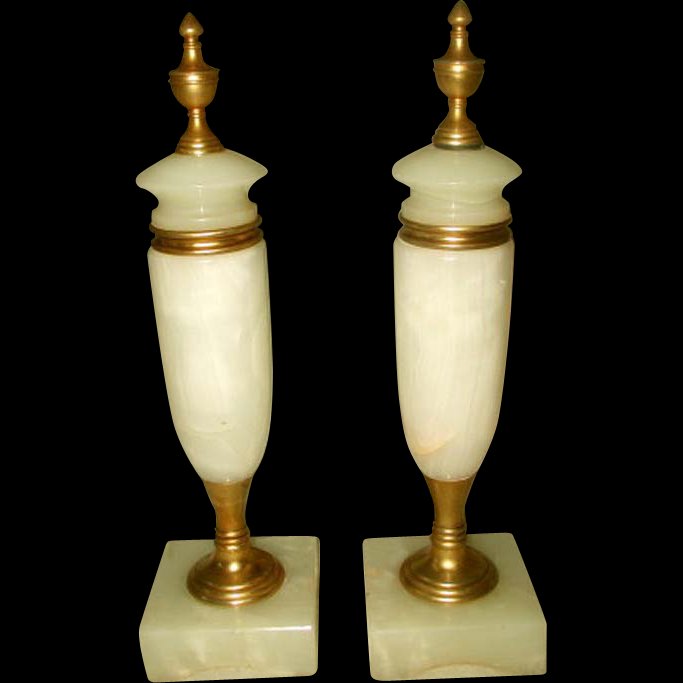Italian Alabaster Cassolettes Bronze 19th Century: Pair of Italian antique cream alabaster cassolettes from the 19th century.Light veining in white and peach tones. Bronze finial caps,collar and pedestal.Stand on square bases with arches. Probably ori