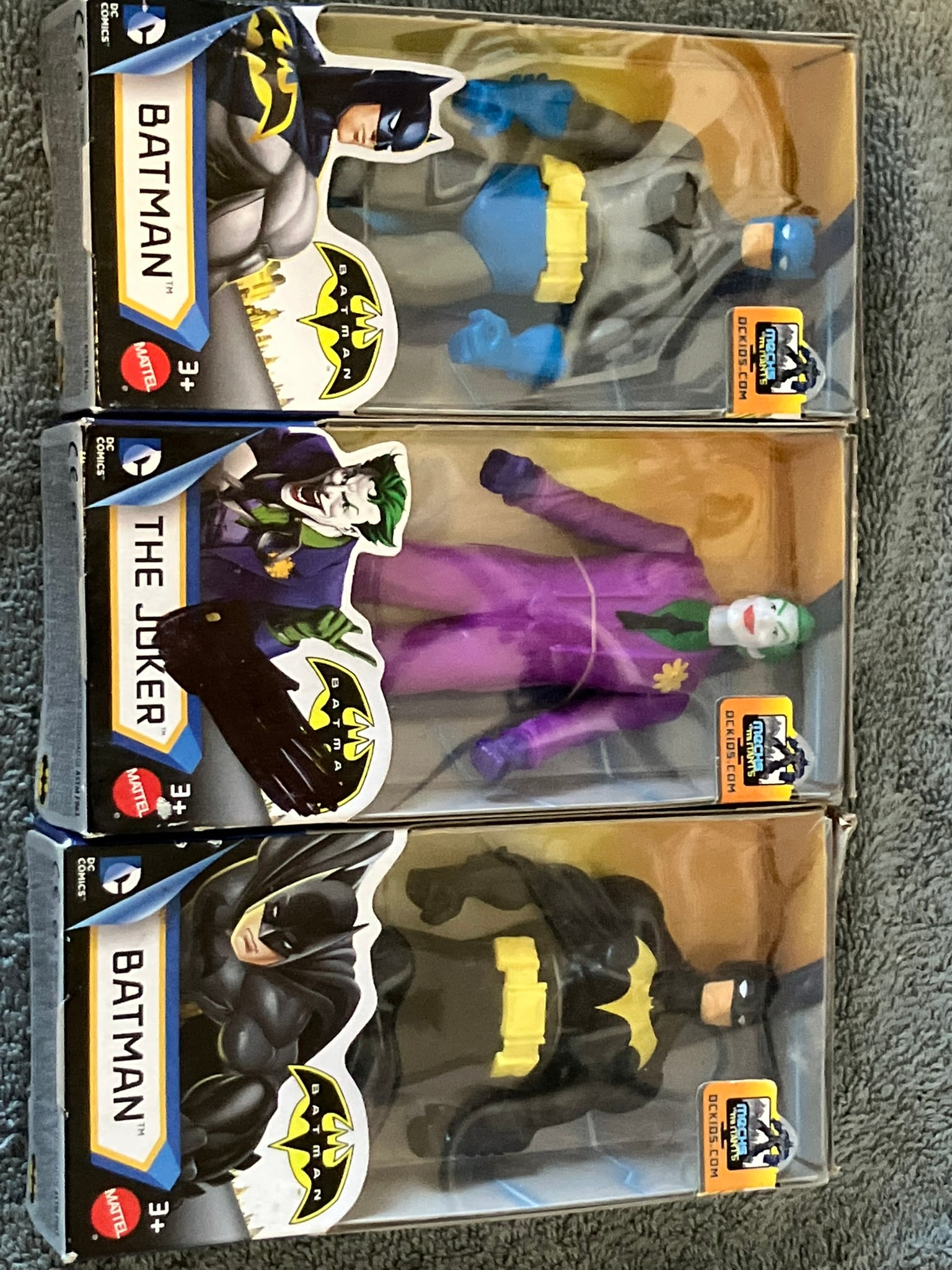 (3) - Batman DC Comics 6in Action Figures: Includes:Batman (Gray/Blue Suit)Batman (Black/Yellow Suit)The Joker (Purple Suit)Each factory-sealed in original box with light shelf wear. Perfect for DC or Batman collectors.