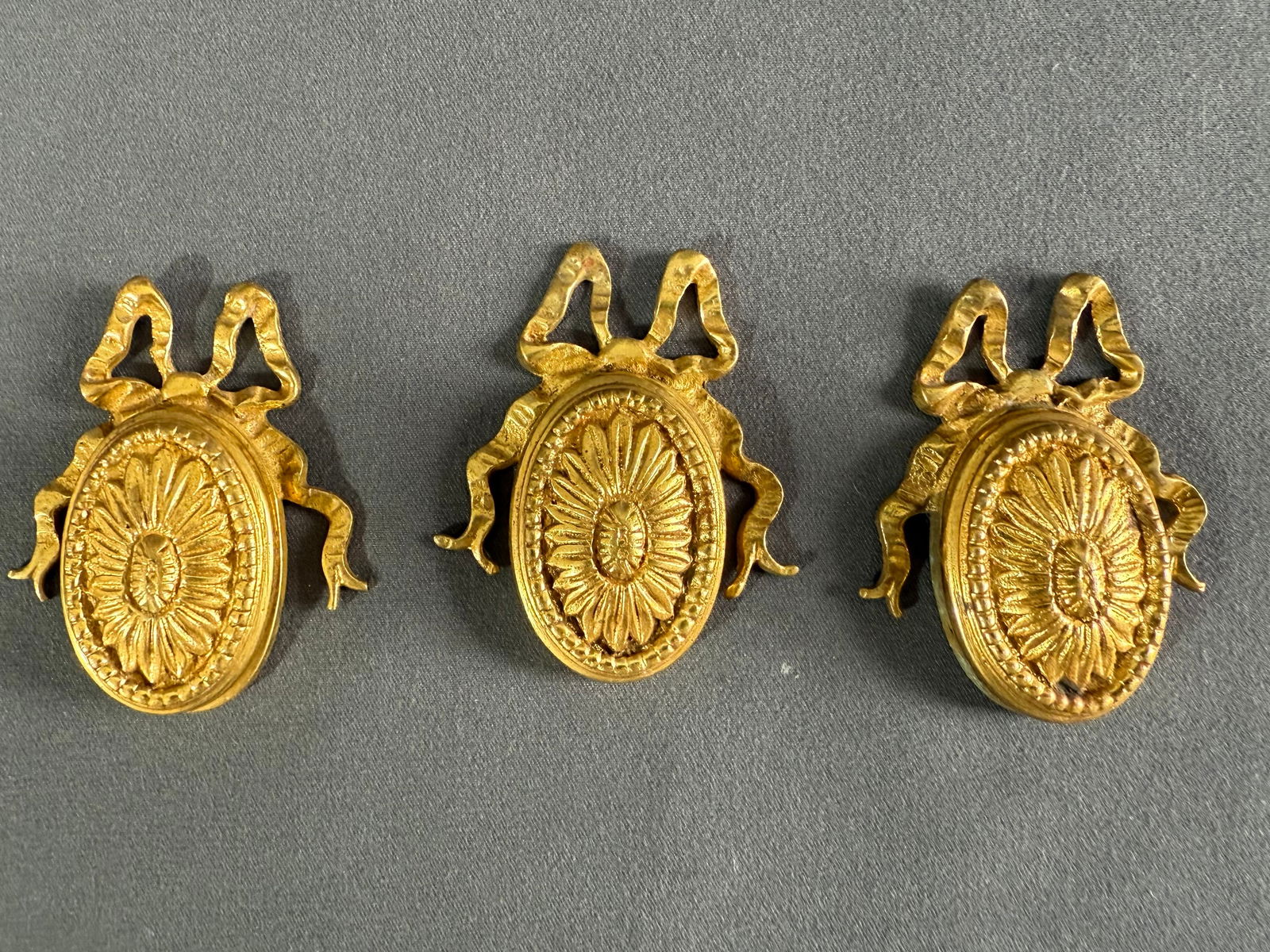 c. 19 French bronze ribbon sunflower burst covered keyhole escutcheons