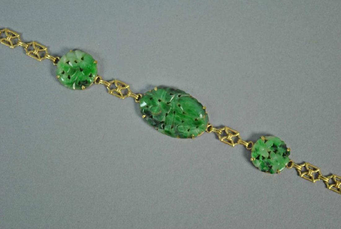 10K CARVED JADE FANCY LINK BRACELET: Set with 3 jade stones, center stone 19x30mm, in yellow gold stamped 10K, 7in., 10.9gms.
