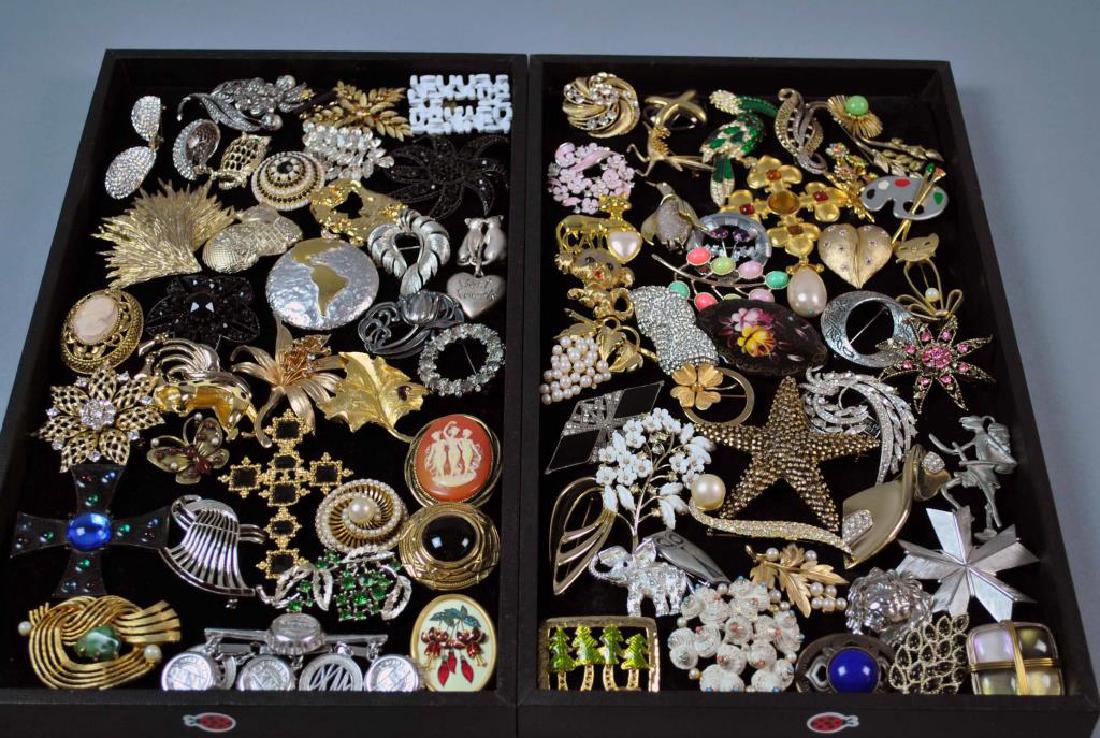 (70+) SIGNED COSTUME PINS: including Lisner, Trifari, Joan Rivers, Warner, Pell, BSK, Givenchi, DKNY, KJL for Avon, Judy Lee, Napier, Pauline Rader, Ivana, Florenza, Ledo, a Russian enameled pin with hand painted florals, etc.,