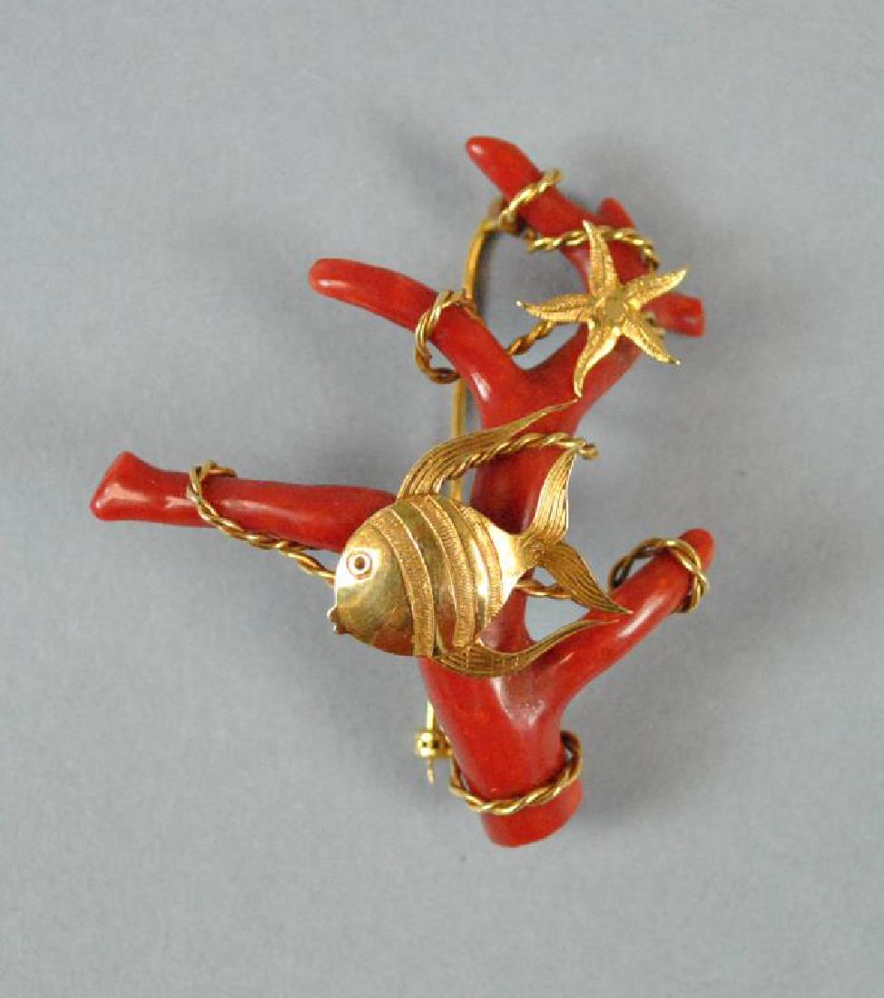 18K GOLD MOUNTED BRANCH CORAL PIN: in fish and starfish design, yellow gold mounting stamped 750, (fish possibly lacking an eye stone, slight bending to pin stem), overall 2x1.9in., gross weight 13.9gms.