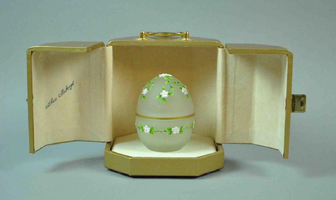 THEO FABERGE LIMITED EDITION CRYSTAL & SILVER EGG: ‘Spring Egg’ for the St. Petersburg Collection, enameled flowers on frosted crystal, the egg opens to reveal a ‘yolk’ seated on an English sterling cup, adorned with a gem-set imperial Russian