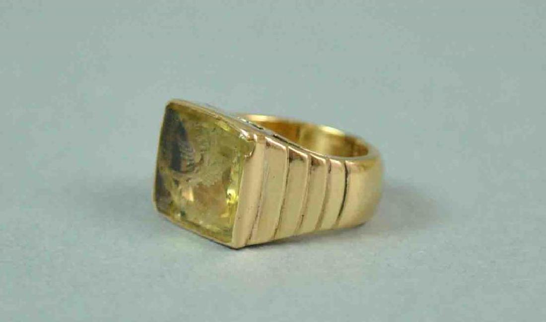 GENTS 14K LIKELY CITRINE INTAGLIO RING: set with an intaglio of a dove with olive branch, overall head 14x16mm, chip abrasion to one bottom corner, carved shoulders, stamped 14K, size 5.5 (sizing line), 15.1gms.