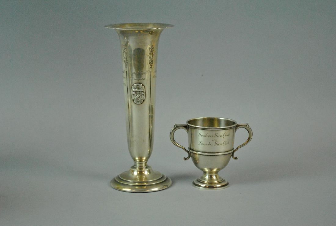 (2) STERLING TROPHYS - SHOOTING & GOLF: including a 2-handled cup, undated and lacking presentation names, but was to be awarded the winner of the "Goshen Gun Club vs. Tuxedo Gun Club, Won by ...", and a weighed trumpet-form vase awarded to