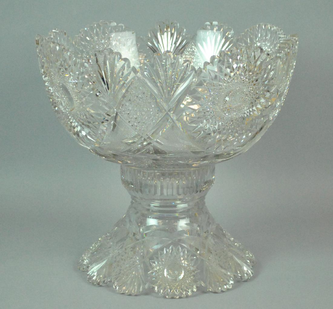 CUT GLASS PUNCH BOWL AND STAND: CUT GLASS PUNCH BOWL AND STAND a few minor dings to teeth, a couple small nicks to body, overall height 13in., diameter14in.