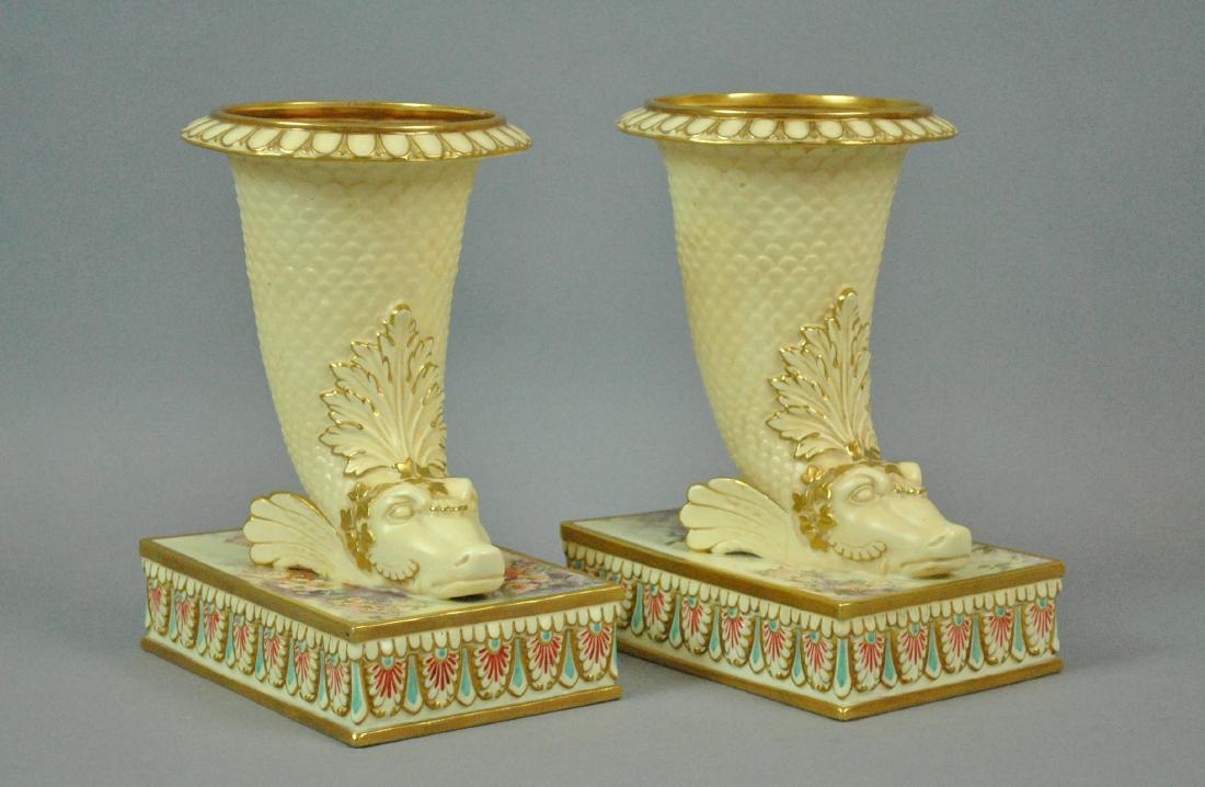 PAIR DOULTON BURSLEM CORNUCOPIA VASES: PAIR DOULTON BURSLEM CORNUCOPIA VASES hand painted, in stylized winged dolphin form with floral and swag decoration, gilt trim and vines, overall good condition (hairline crack to interior of one), he