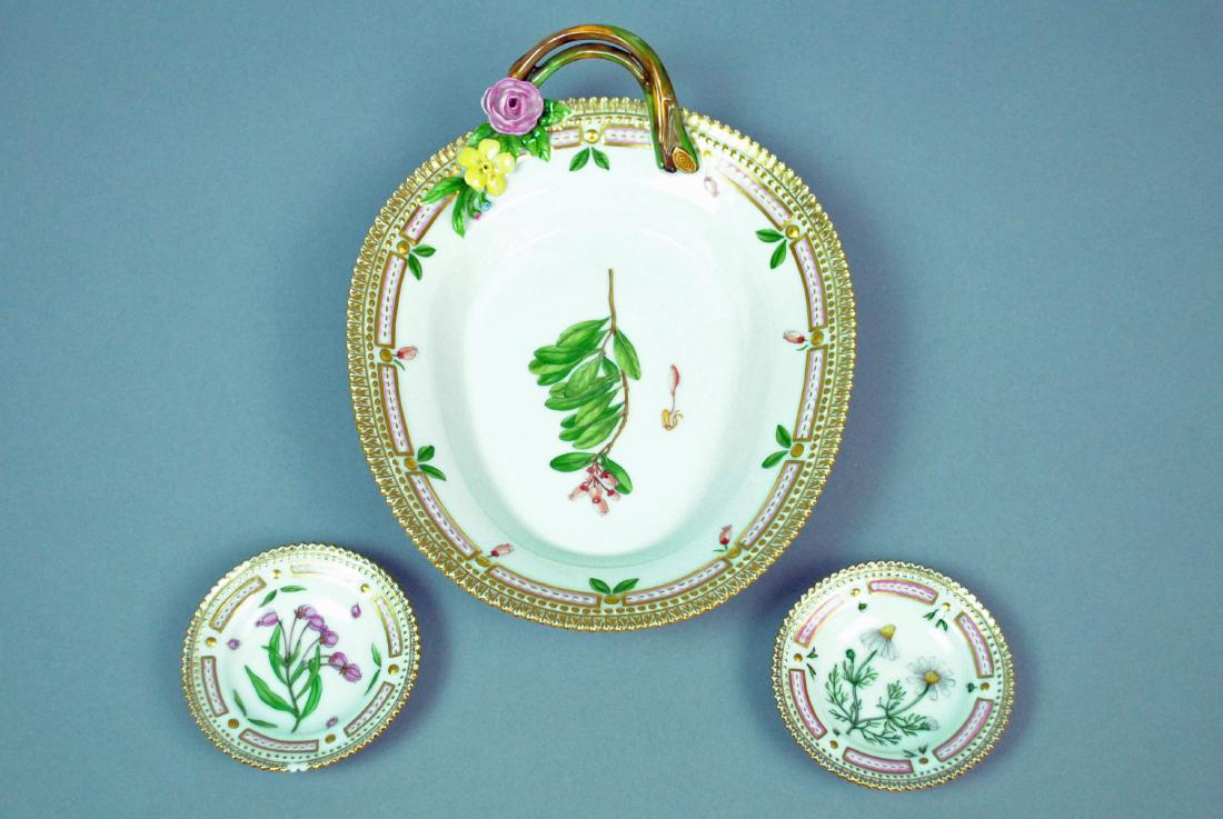 (3) ROYAL COPENHAGEN FLORA DANICA TABLEWARES: (3) ROYAL COPENHAGEN FLORA DANICA TABLEWARES including an oval serving dish with vine handle (small petal flake), 9x6.5in., and 2 butter pats (one with edge chip), 3in.