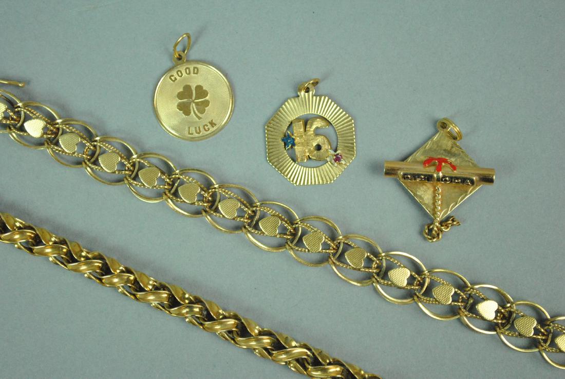 (2) 14K CHARM BRACELETS AND (3) CHARMS: (2) 14K CHARM BRACELETS AND (3) CHARMS including a heart motif bracelet, width 11.7mm, (13.7gms.), a braided form bracelet, width 6.3mm, (18.5gms.), each 7.5in., and 3 charms including a graduation ca