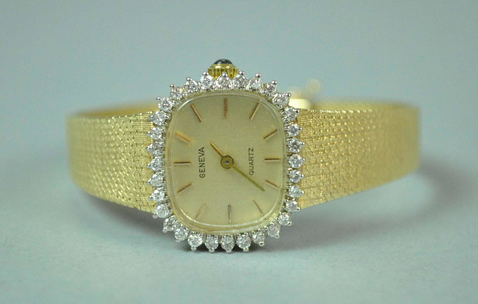 LADIES GENEVA GOLD & DIAMOND BRACELET WATCH: LADIES GENEVA GOLD & DIAMOND BRACELET WATCH 20x22mm, bezel set with 31 round melee diamonds, dial marked 'Geneva Quartz', case stamped 14K, and with personal inscription dated 1993, clasp stamped 14K,