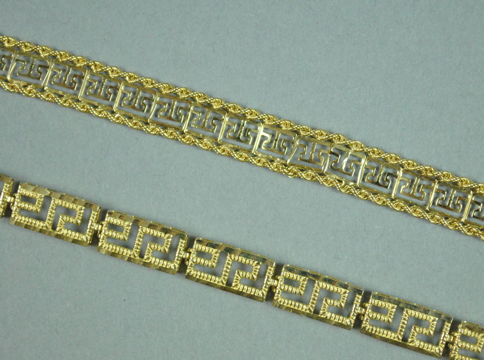 (2) FANCY LINK BRACELETS: (2) FANCY LINK BRACELETS including one in Greek key design, 8in., and one with rope trim (slight kinks), 7in., each stamped 14K, gross weight 11.7gms.