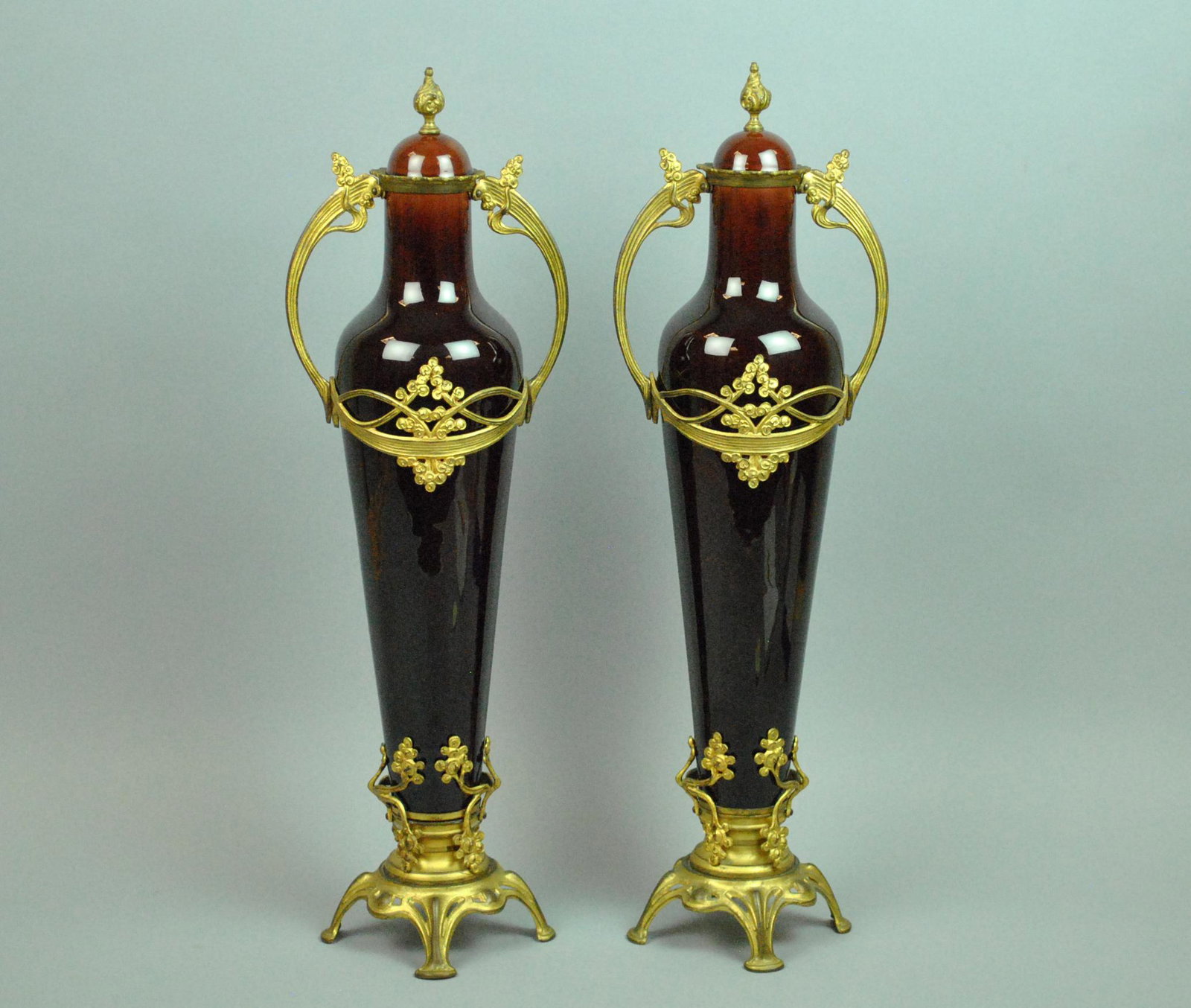 PAIR TALL ART NOUVEAU PORCELAIN MOUNTED URNS: PAIR TALL ART NOUVEAU PORCELAIN MOUNTED URNS with covers, metal mounted, likely brass, lid interiors numbered 8924, overall good condition other than a random rub or glaze pop, some minor natural sepa