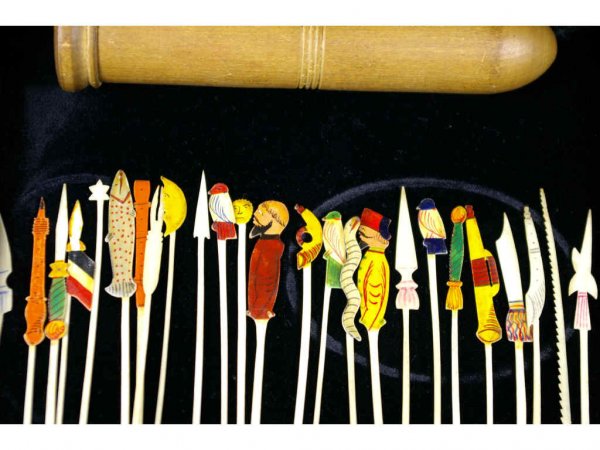 VINTAGE WOOD SEWING CASE: with assorted grouping of hand-painted implements attributed to bone, depicting a fish, sun, half moon, birds, snake, bearded gents, rockets, etc.