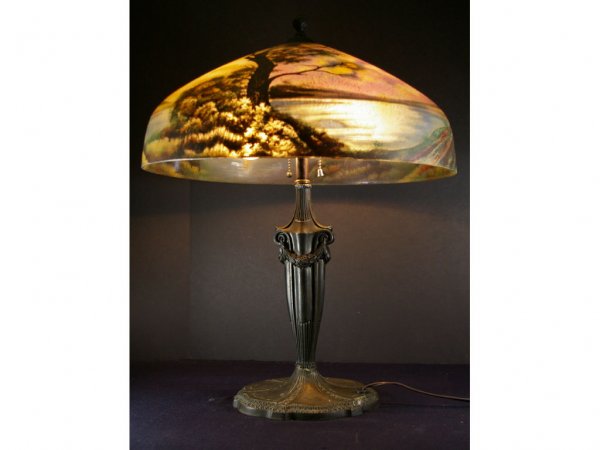 PITTSBURGH REVERSE PAINTED LAMP: with moonlit lake scenic, partial Pittsburgh paper label inside shade, iron and spelter base with double socket pull chain, diameter of shade 18in., overall height 23in.