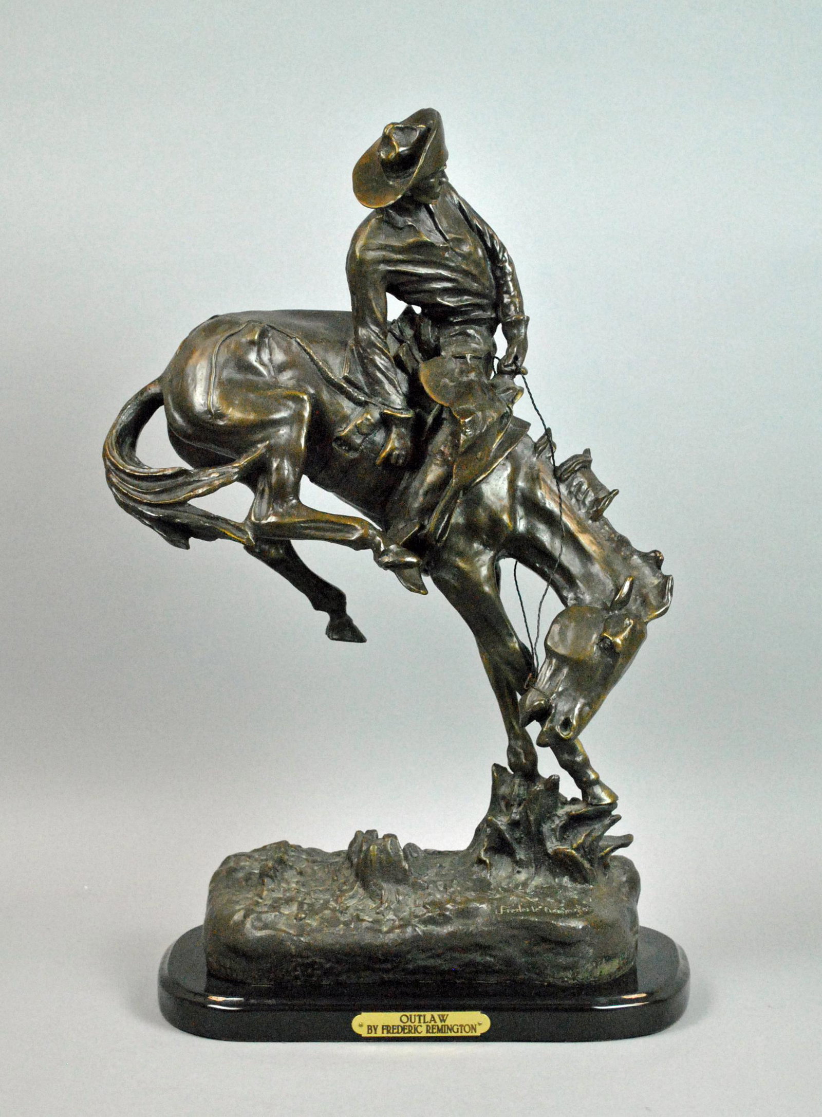 AFTER FREDERICK REMINGTON - OUTLAW: large bronze on black marble base, ground signed 'Frederick Remington', placard bearing artist and title, bronze in overall good condition, overall height 24in.