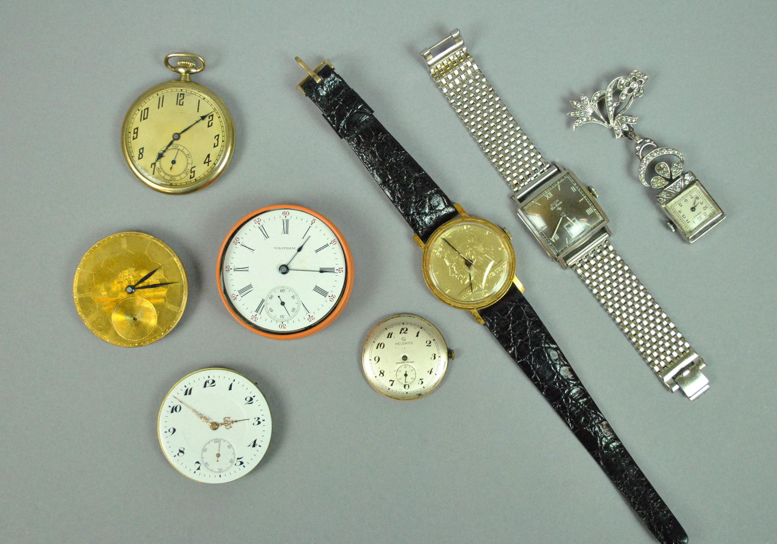 (9) PIECE WATCH & WATCH MOVEMENT GROUP: includes Bucherer quartz pocket watch with chain (likely needs a battery), a (new?) Waltham 15 jewel pocket watch movement #15921380 (1907) in a Jewelmont tin, a Longines pocket watch 15 jewel movemen