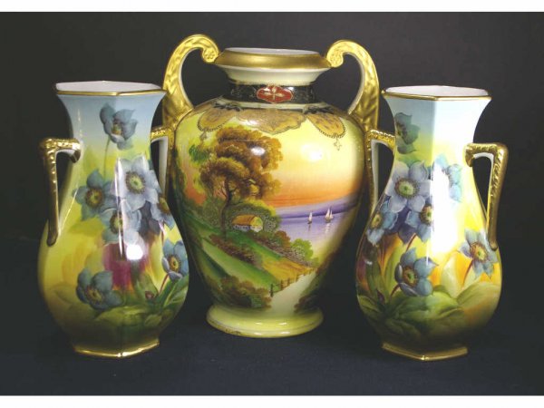 THREE NORITAKE VASES: comprising a 9" vase with lakefront cottage scene, and a pair of 8" floral vases