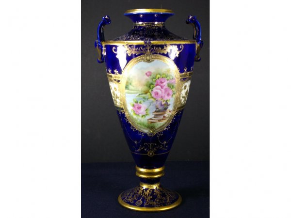 NIPPON PORCELAIN COBALT VASE: heavily decorated in hand-painted rose medallions, gilded scrollwork and beaded swags, unmarked, repaired base, 14.5in. Literature: Collector's Encyclopedia of Nippon Porcelain, Fourth Series, John Va