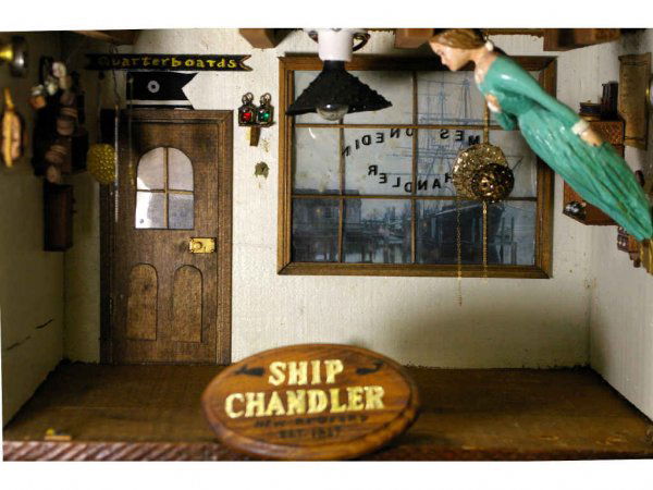 NAUTICAL THEME ROOM DIORAMA: "Ship Chandler est. 1827", custom designed by Jeanne Knoop in 1974 to represent a nautical salesroom, with a fully stocked assortment of nautical items including a hand-carved figurehead woman, whalin
