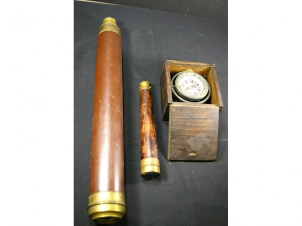 TWO NAUTICAL SPY GLASSES AND A LIQUID COMPASS: comprising a 9" and 20" leather and brass spy glass, and a liquid compass in a slide-lid oak box, 3x5x5in. The Knoop Collection
