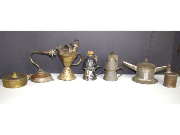 SEVEN EARLY LIGHTING DEVICES: most in tin, tallest 11in. including handle The Knoop Collection
