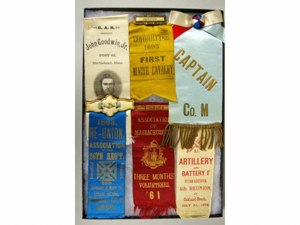 DISPLAY BOX GROUP OF 6 GAR PINS AND RIBBONS: including a First Maine Cavalry 1893 Committee ribbon and pin / a GAR John Goodwin Jr. Post 82 Marblehead Mass. ribbon / an 1863 Reunion Connecticut Volunteers 25th Regiment 1863-1888 ribbon and hands