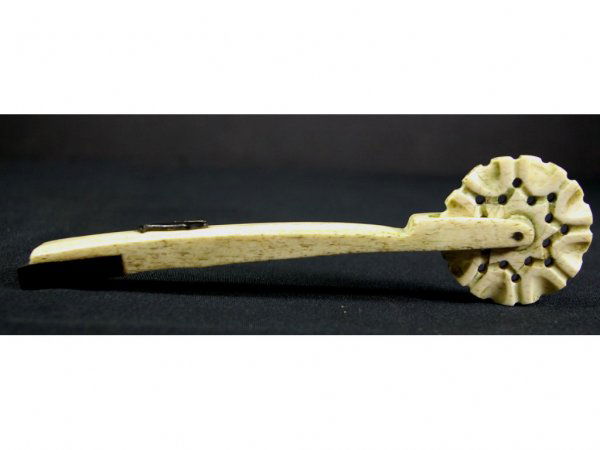 EBONY & IVORY PIE CRIMPER WITH CARVED SPERM WHALE: likely the work of a 19thC. whaler, 2" wheel, overall 7in. The Knoop Collection