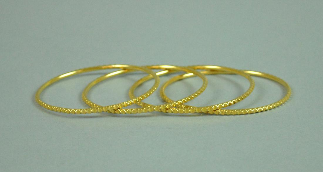MATCHING SET OF FOUR 18K BANGLES (1 of 2)