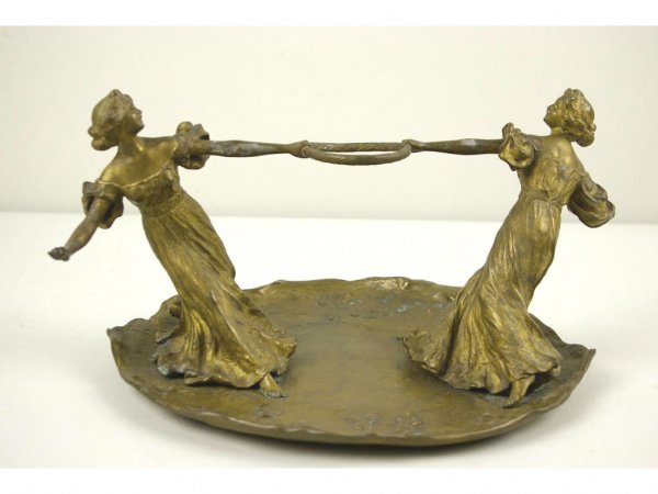 NAM GREB (FRANZ BERGMAN) (Austrian, 1838-1894): Viennese gilt bronze centerpiece depicting two nouveau young ladies playfully tugging on a ring, on a leaf-form base decorated with clover, 8x12in.