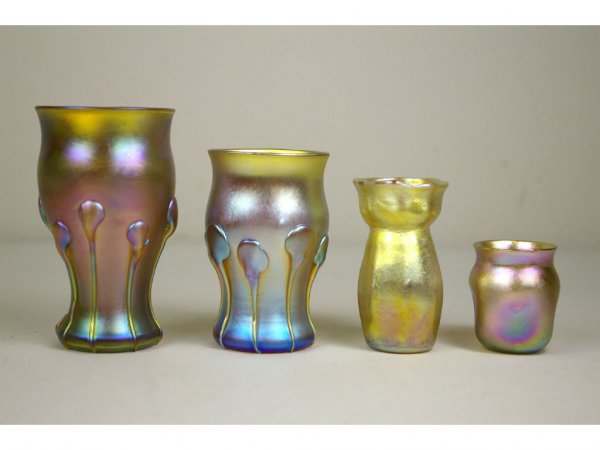 FOUR L.C. TIFFANY GOLD FAVRILE ITEMS: 3" bud vase signed L.C.T. W8862, a 2" toothpick holder with pinched body signed L.C.T. T3628, a 4" cabinet vase with applied lappets signed L.C.T. H1146, and a matching 2.5" cabinet vase signed L.C.T.