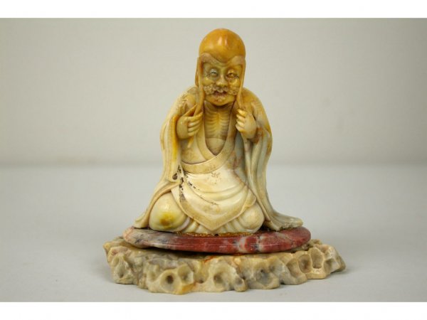 A FINELY CARVED SOAPSTONE FIGURE OF A SEATED LOHAN: kneeling on a rouge soapstone plateau, 5in.