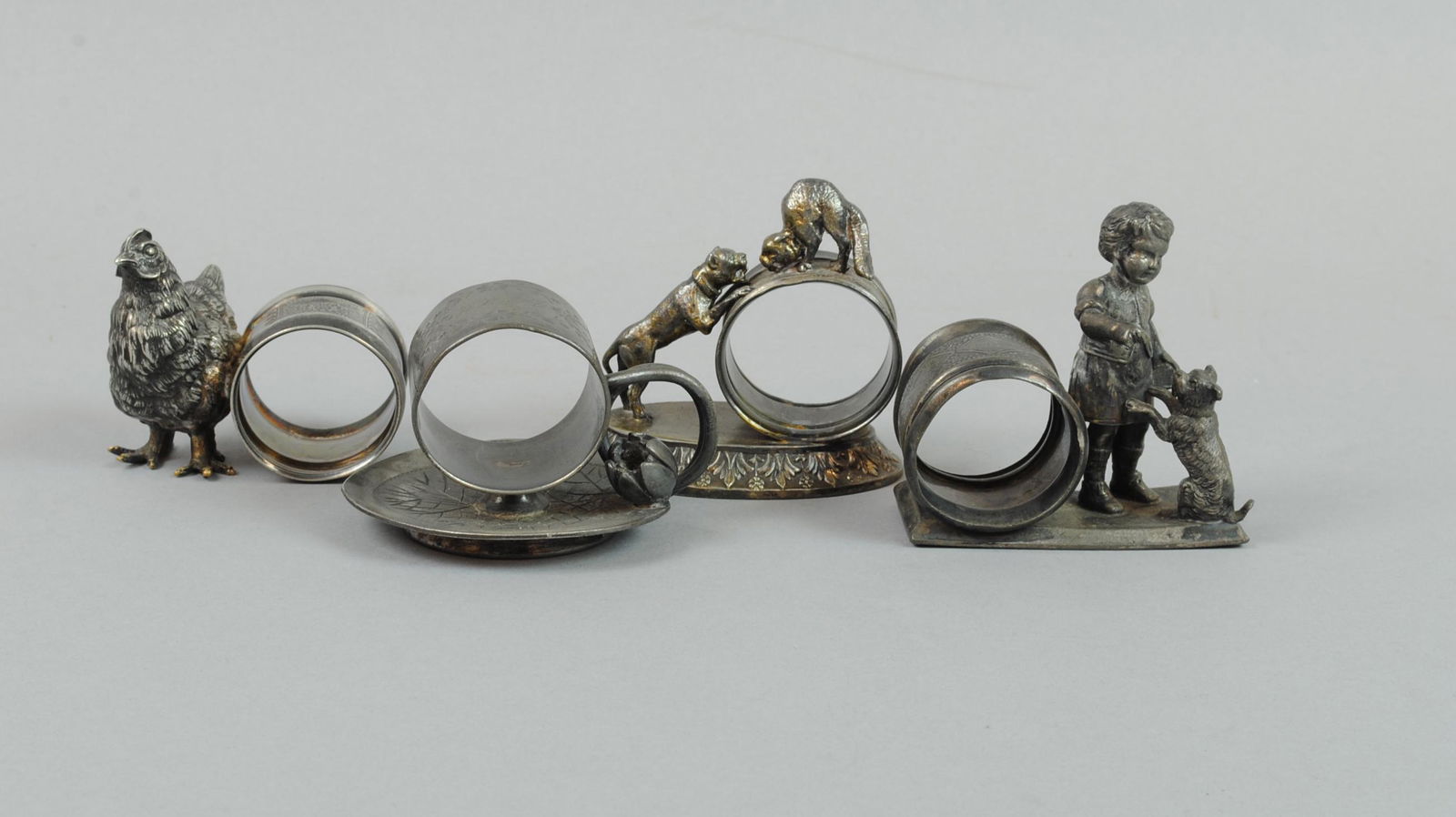 (4) MERIDEN SILVERPLATE FIGURAL NAPKIN HOLDERS (1 of 1)