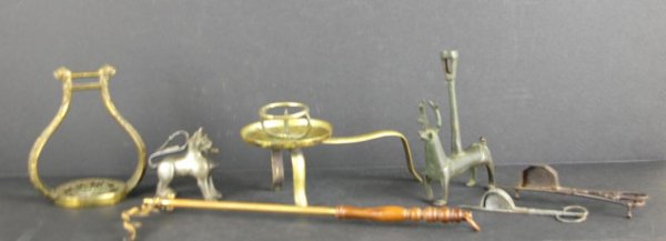 SEVEN LIGHTING RELATED METALWARE ARTICLES: including a footed candle pricket, an animal-form Roman-style lamp, wick cutters, etc. The Knoop Collection