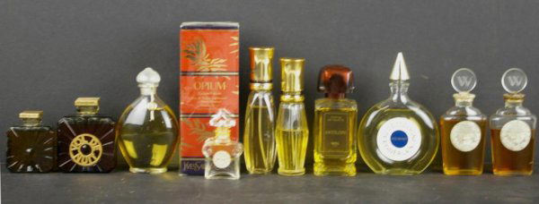 GROUP OF ELEVEN VINTAGE PERFUME & COLOGNE BOTTLES: including Guerlain "Vol de Nuit", Guerlain "Mitsouko", Weil "Antilope", and a limited edition unopened Yves Saint Laurent "Opium" in original box