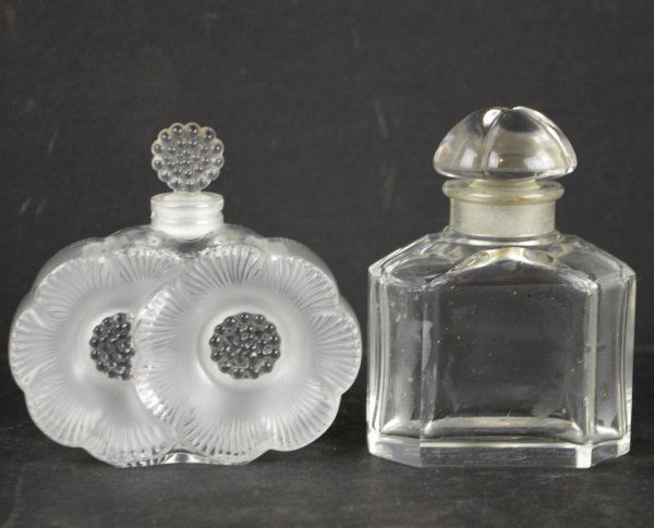 TWO SIGNED FRENCH CRYSTAL PERFUME BOTTLES: including a Guerlain bottle marked "Baccarat" and a floral design bottle marked "Lalique", 3.5in.