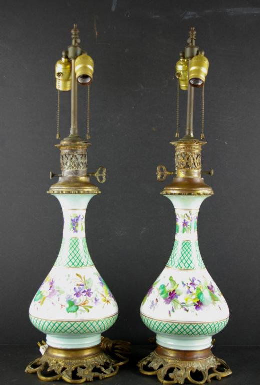 PAIR OF HAND-PAINTED AND ENAMELED TABLE LAMPS: in porcelain with floral and vine motif, brass mounts, overall height 28in.