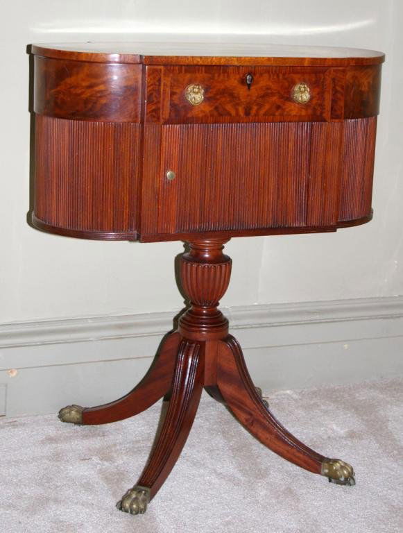 AMERICAN FEDERAL FIGURED MAHOGANY WORK TABLE: attributed to the workshop of Duncan Phyfe, the hinged top opening to a fitted interior with compartmented trays centering a ratcheted writing surface, the tambour door opening to a shelved interior,