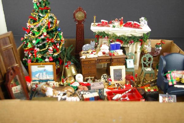 CONTENTS OF HOLIDAY DIORAMA BY JEANNE KNOOP: miniatures include Christmas tree with trimmings, brass andirons and candlesticks, tall case clock, paneled screen, wing chair, federal-style mirror, wagon, framed painting, nutcrackers, rug, etc, c.1