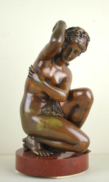 BRONZE SCULPTURE OF A DRAPED NUDE: in classical style, seated upon a tortoise, raised on a red marble circular base, overall height 12in.